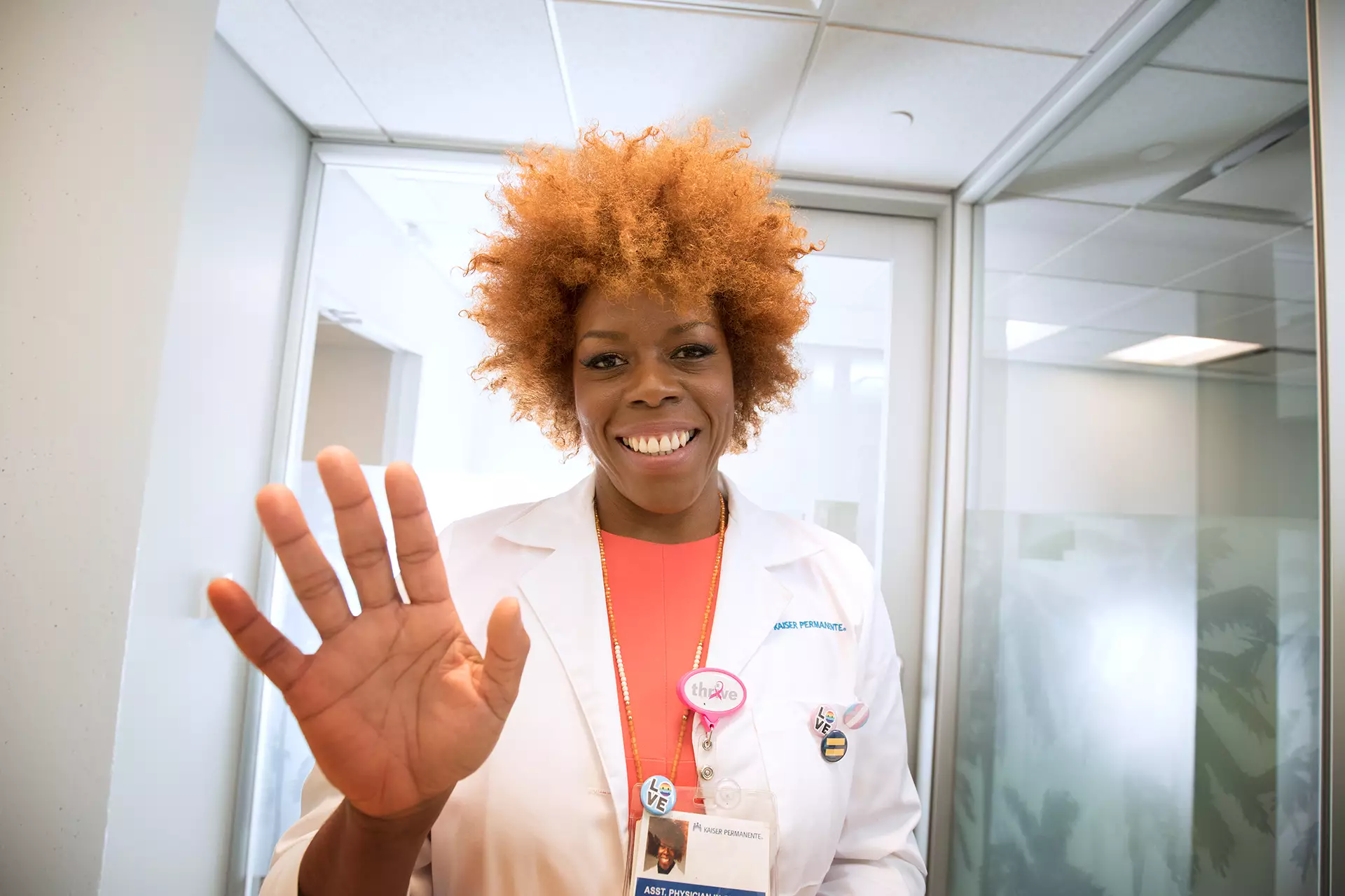Doctor waving to patient on e-visit