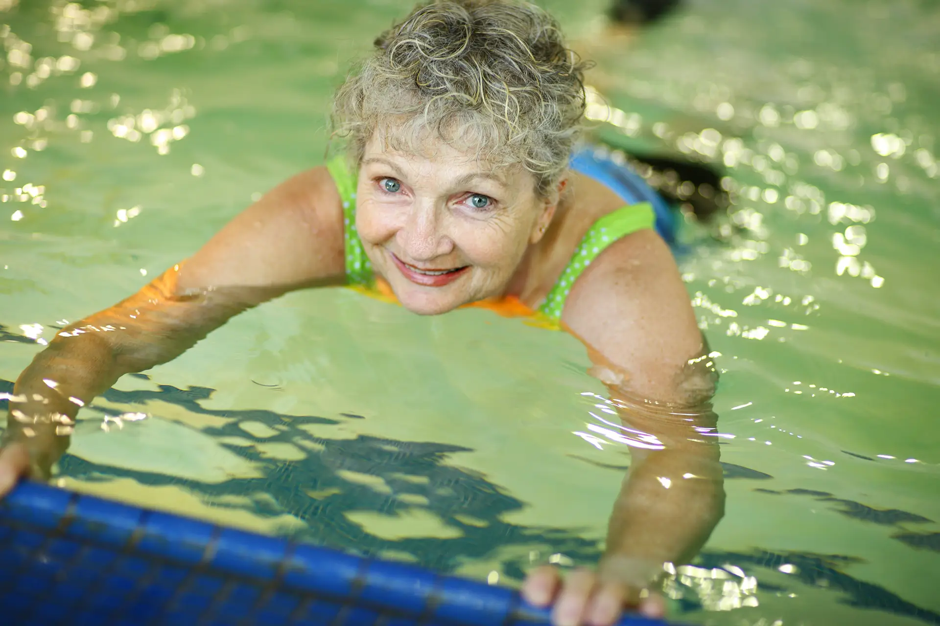 Elderly woman in swimming pool
